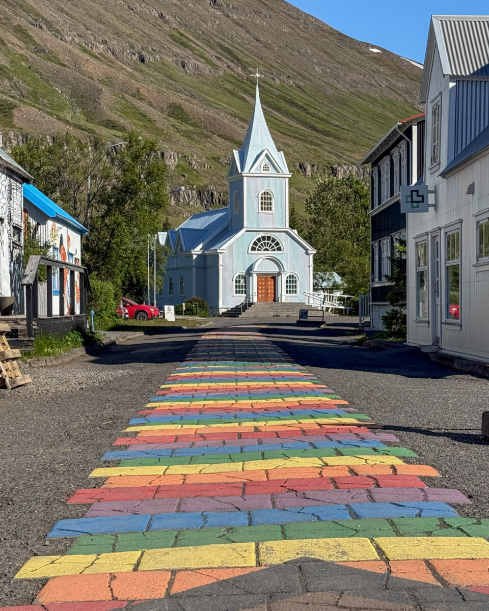 Blue church and rainbow street in Seyðisfjörður