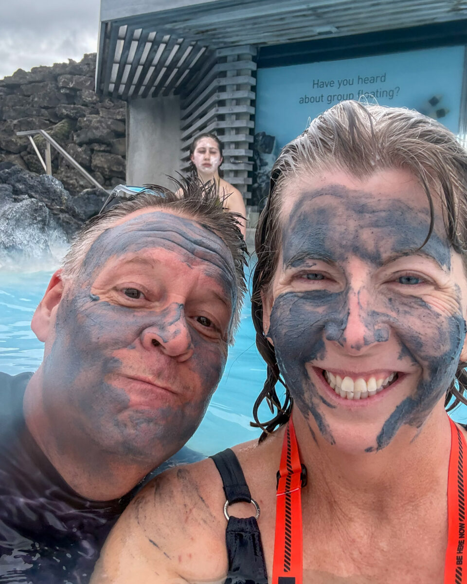 Pete and Susan with mud masks in the lagoon